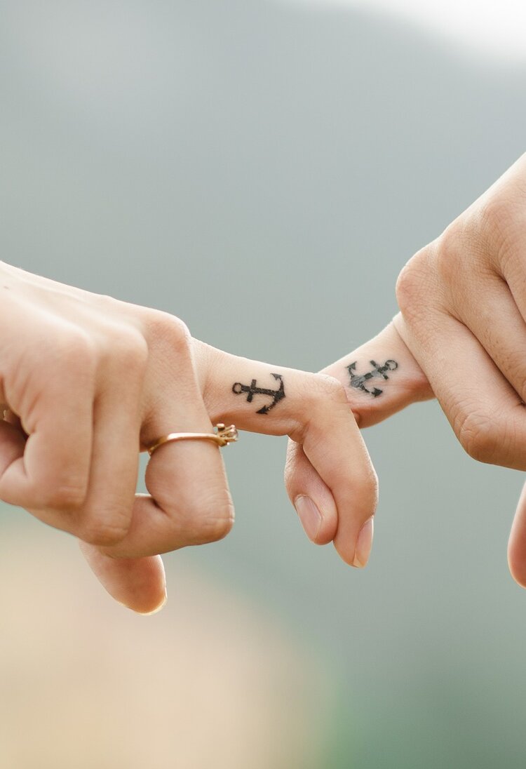zwei Hände mit Tattoos halten sich | © pixabay