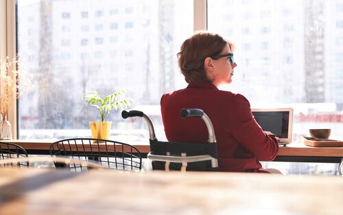 Eine Frau sitzt an ihrem Arbeitsplatz Zuhause und schaut gedankenverloren aus dem Fenster. | © pexels