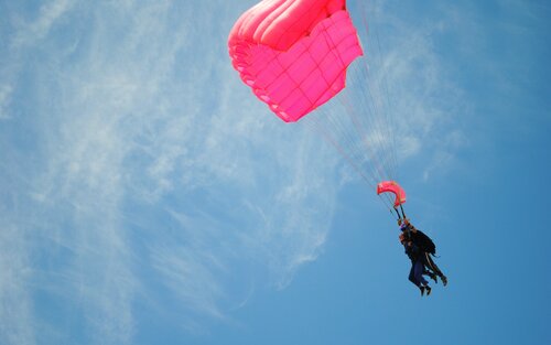 Foto eines Fallschirmspringers in der Luft. | © unsplash