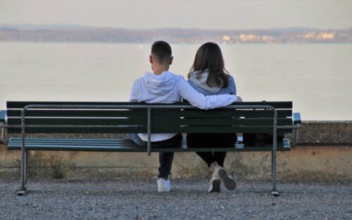 Ein Paar sitzt auf einer Bank vor einem See. | © pixabay